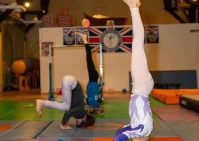 Young gymnast learning a beginner headstand during KCGA Easter Week 2026 in Kensington London