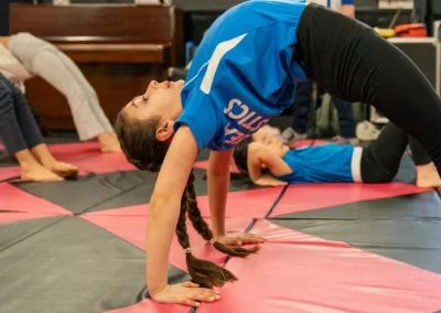 Child performing a bridge stretch on the floor during gymnastics classes in Belgravia London