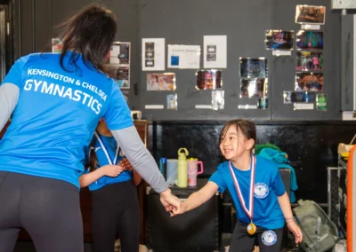 Child receiving a medal after gymnastics training in Knightsbridge London