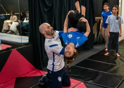 Dr Stefan Kolimechkov coaching a child performing a back tuck somersault in Knightsbridge London