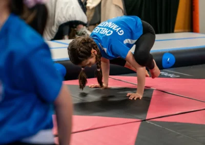 Child performing a frog balance strength exercise during gymnastics classes in Knightsbridge London