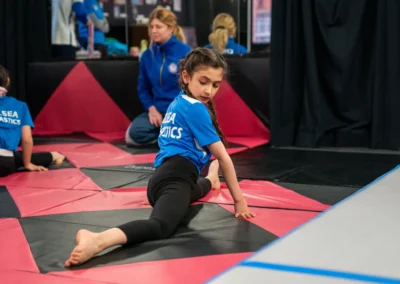 Child performing a front splits stretch during gymnastics training in Knightsbridge London
