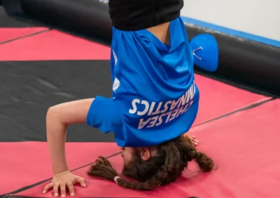 Child performing a headstand during gymnastics classes in Knightsbridge London