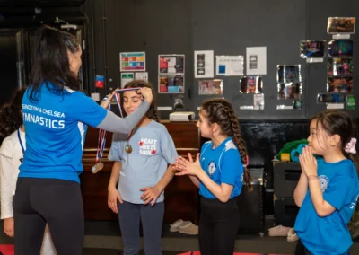 Children receiving medals after gymnastics classes in Knightsbridge London