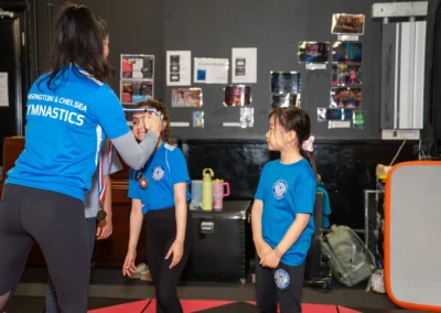 Child receiving a gymnastics medal after classes in Knightsbridge London