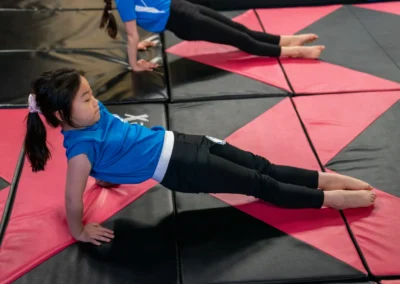Child performing a reverse plank exercise during gymnastics training in Knightsbridge London