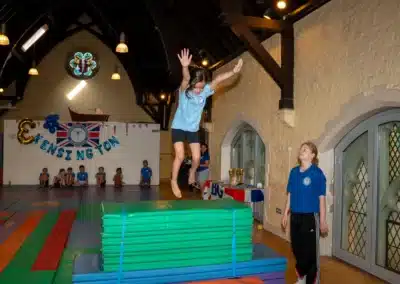 Young gymnast practicing jump skills during KCGA Annual Performance 2025 in Kensington, London.