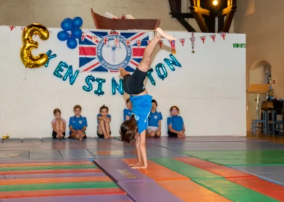 London gymnast performing a cartwheel during KCGA Annual Performance 2025 in Kensington, London.