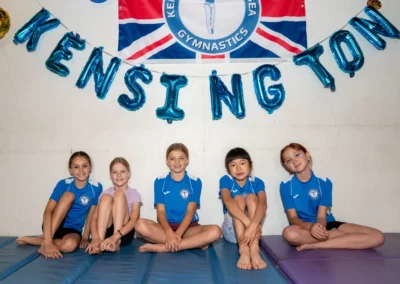 KCGA gymnasts sitting together during the Annual Performance event in Kensington, London.