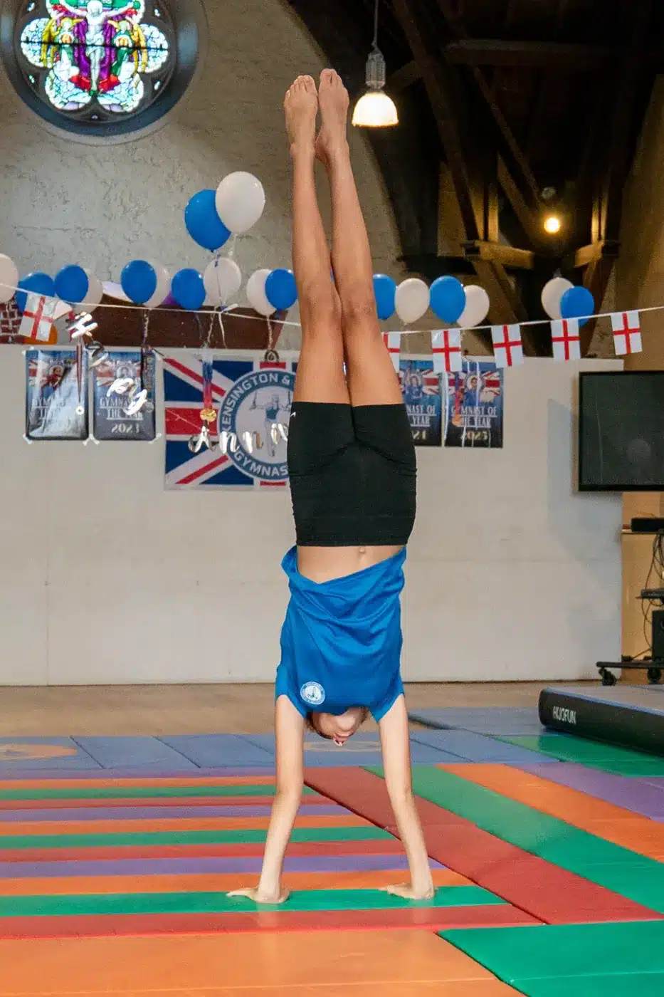 KCGA gymnast holding a handstand during Annual Performance 2026 at St Philip's Church