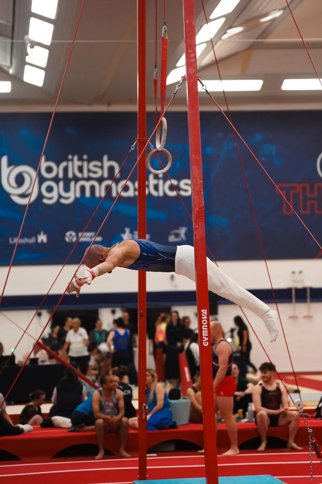 Dr Stefan Kolimechkov moving through a still-rings sequence at the 2026 Adult Gymnastics British Championships