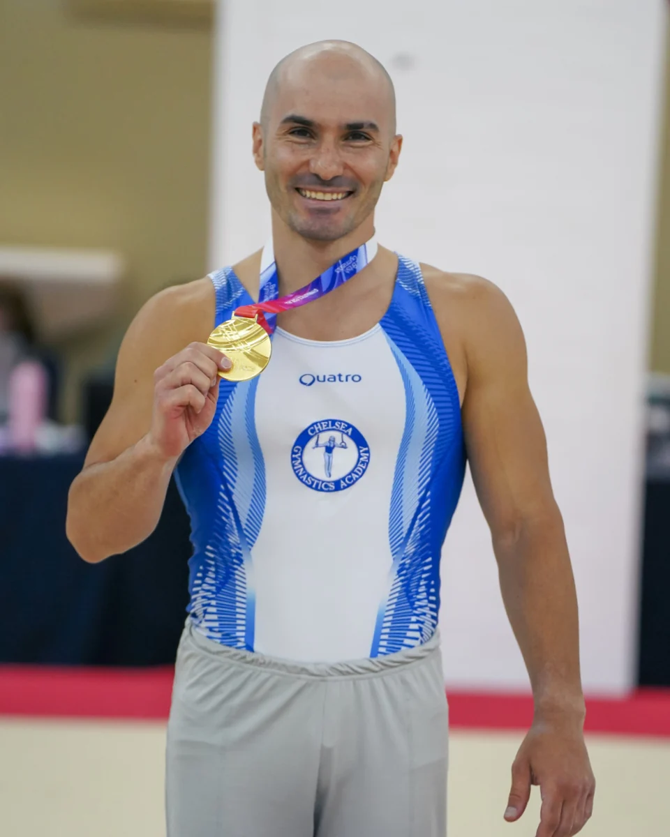 KCGA Director Stefan Kolimechkov holding his gold medal at the 2024 Adult Gymnastics British Championships