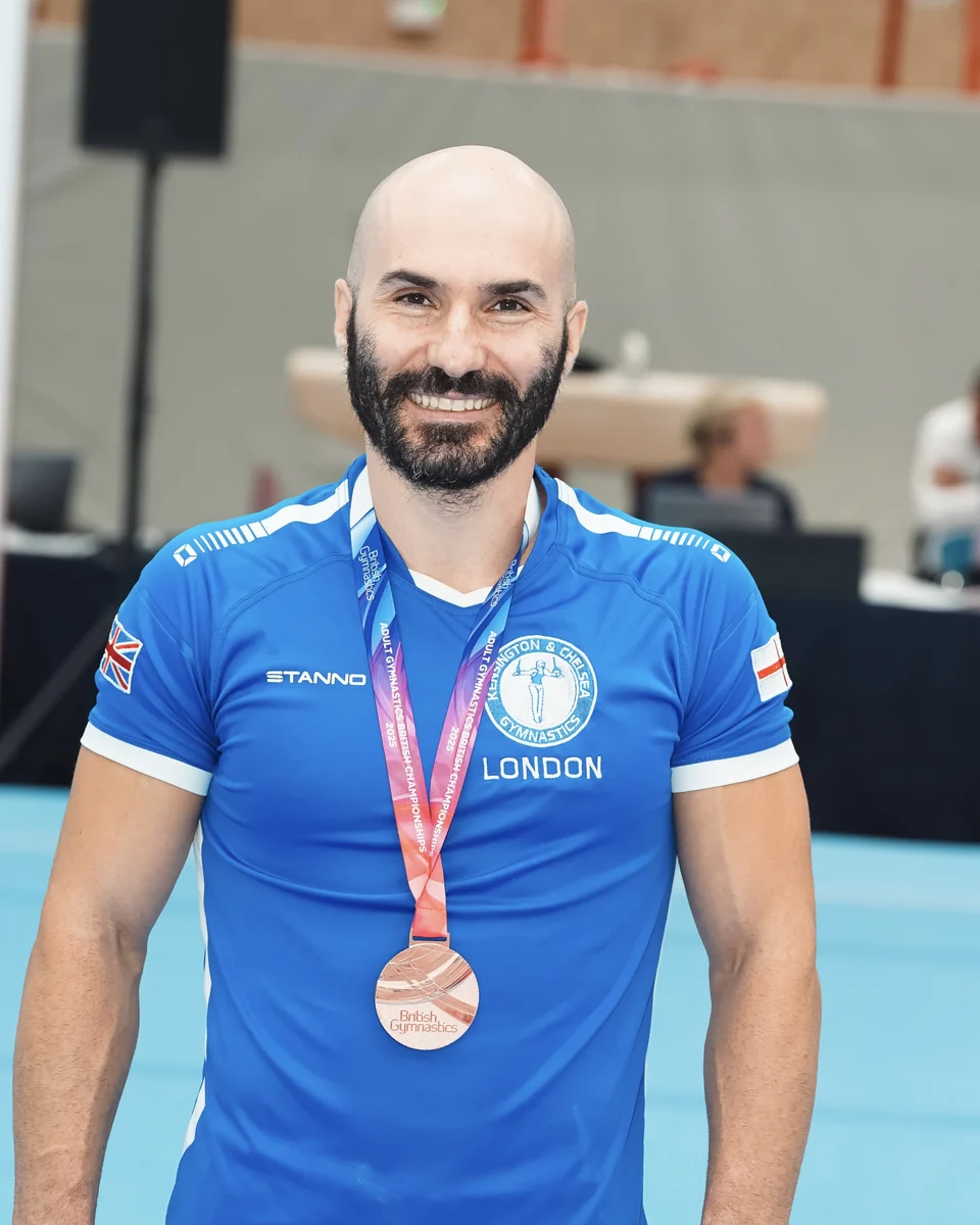 KCGA Director Stefan Kolimechkov wearing his bronze medal at the 2025 Adult Gymnastics British Championships