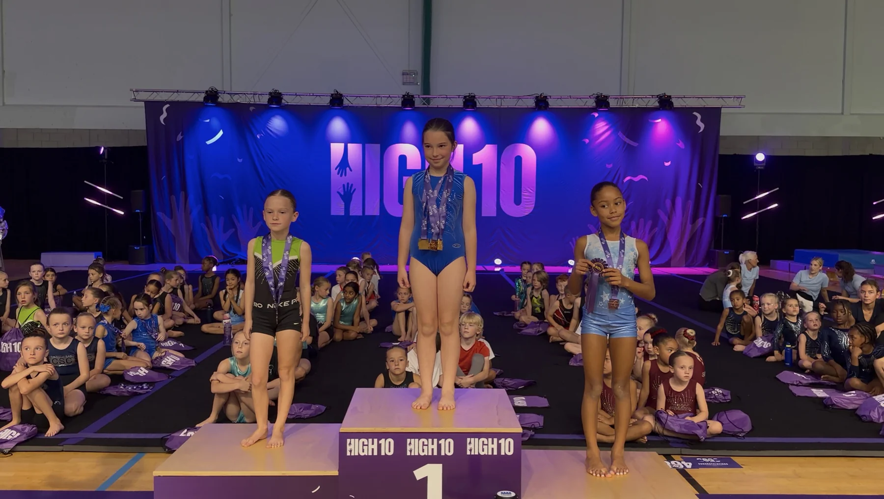 Taya on the podium with her bronze Floor medal at the 2026 High10 Events – Essex Invitational
