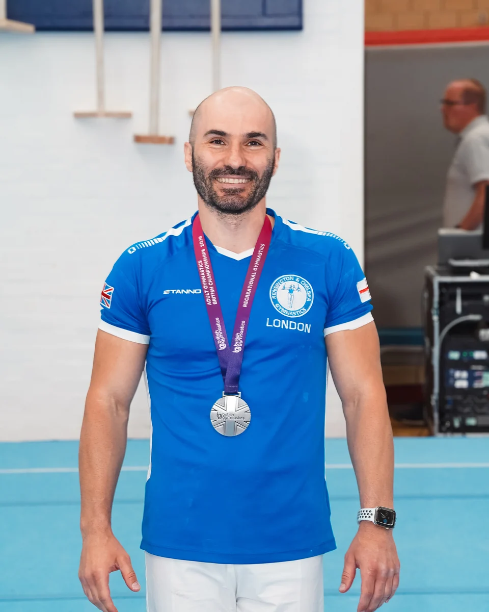 KCGA Director Stefan Kolimechkov wearing his silver medal at the 2026 Adult Gymnastics British Championships
