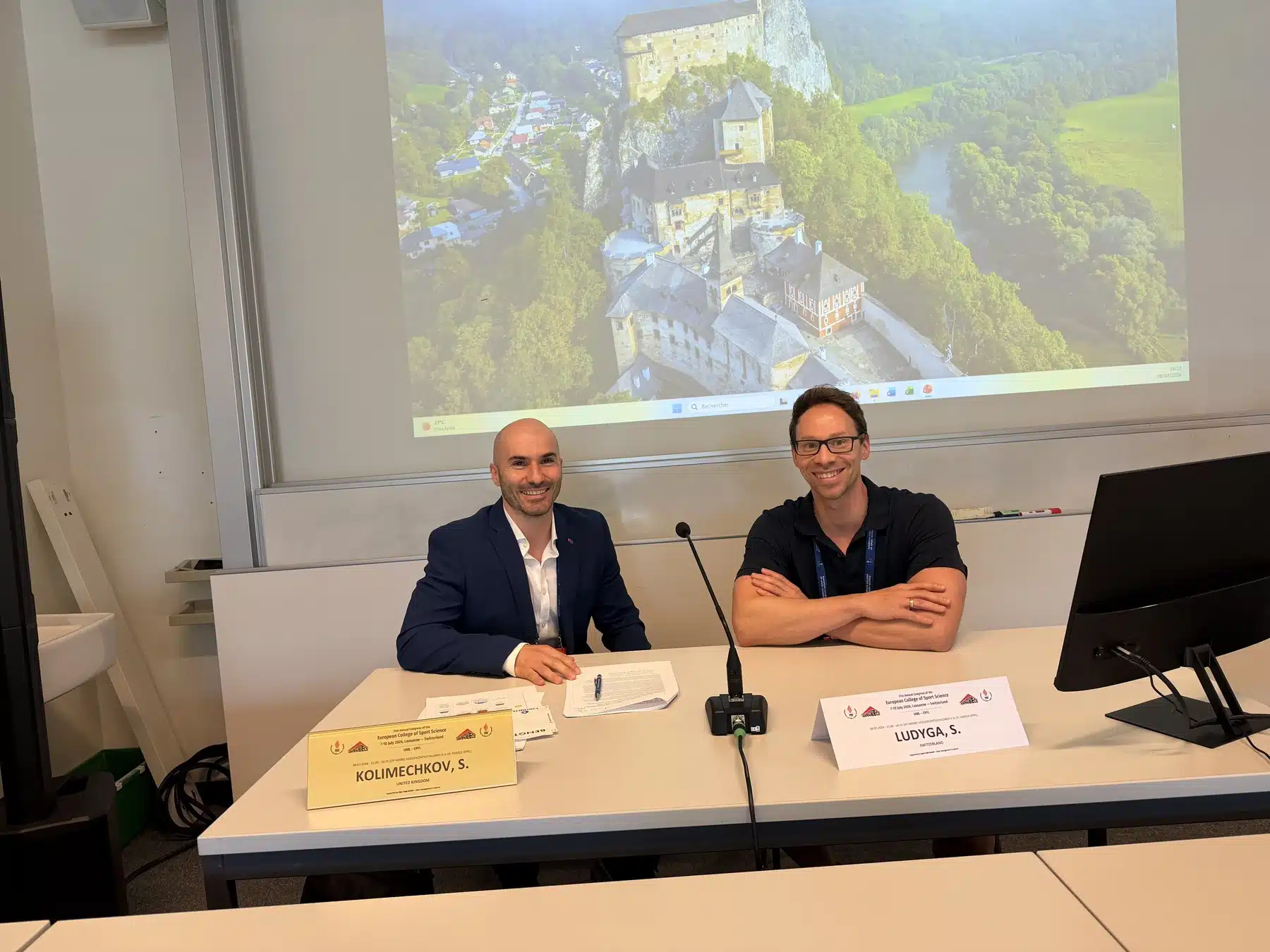 Dr Stefan Kolimechkov and Sebastian Ludyga at the chair desk at ECSS Lausanne 2026