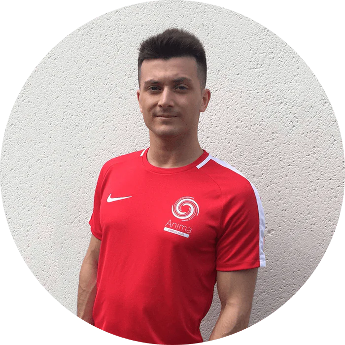 Portrait of Lorenzo Ribecca wearing a red Anima Gymnastics shirt.