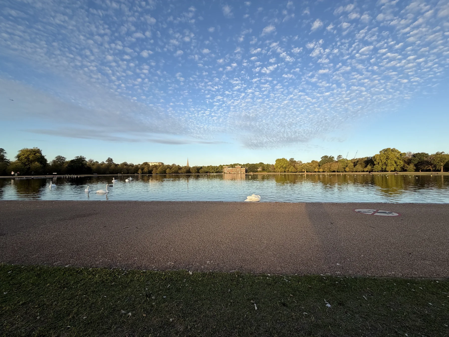 A wide view across the Round Pond towards Kensington Palace in September 2026.